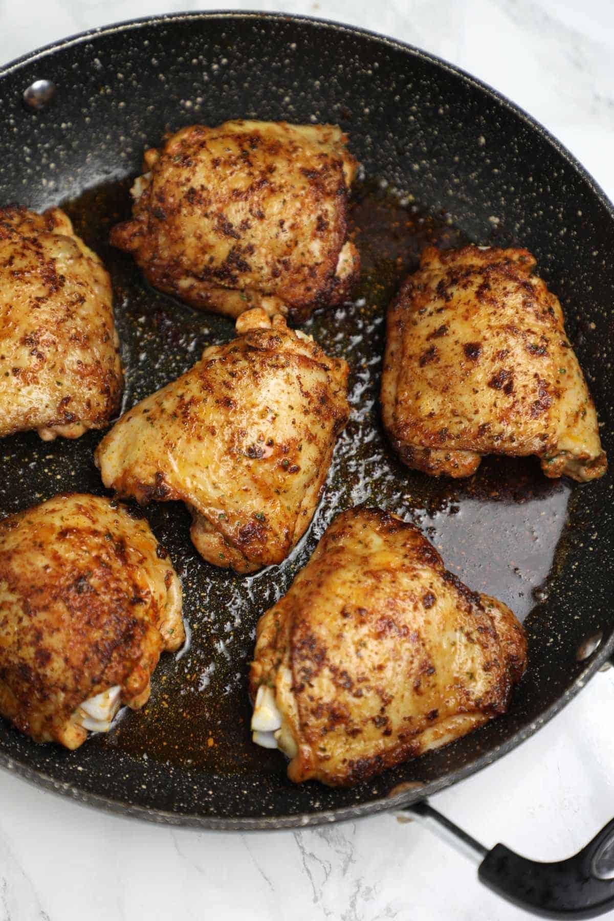 Preparing chicken thighs in a pan